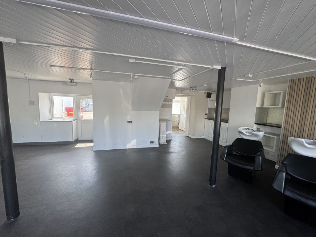 Lot: 65 - TWO STOREY COMMERCIAL UNIT WITH POTENTIAL, DETACHED BLOCK OF FOUR GARAGES AND CAR PARK - Ground floor area taken from window
